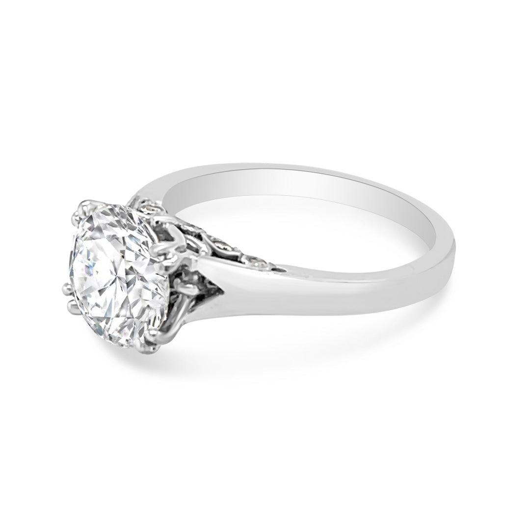 Solitaire Engagement Ring With Round Diamond and Decorated Bridge